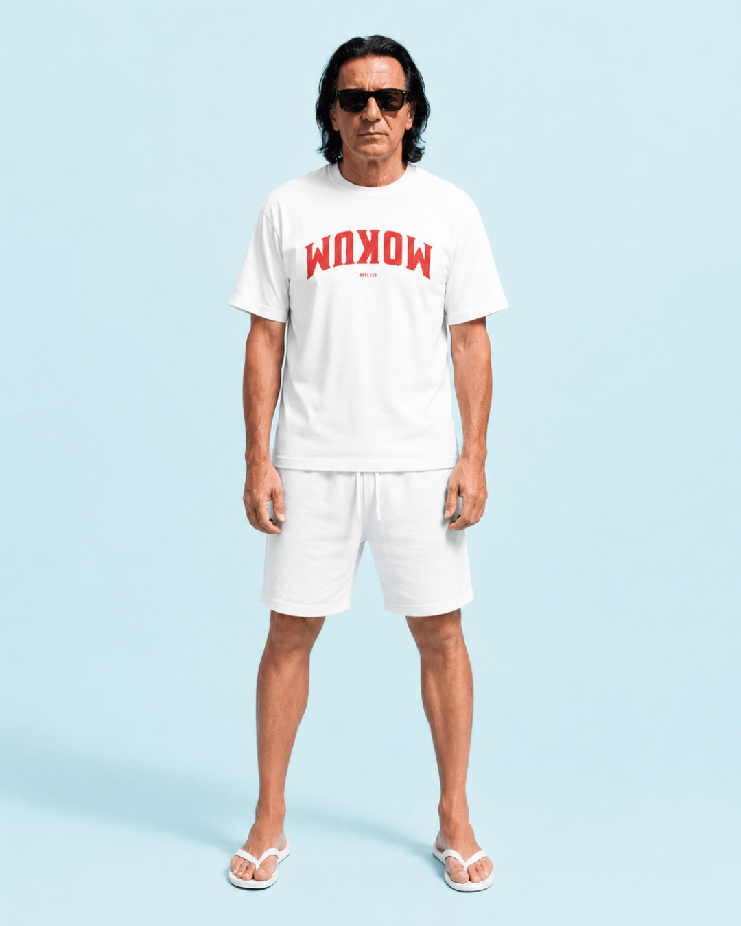 Mokum Est. 1300 T-shirt | Local Legend worn by a man against a blue background.