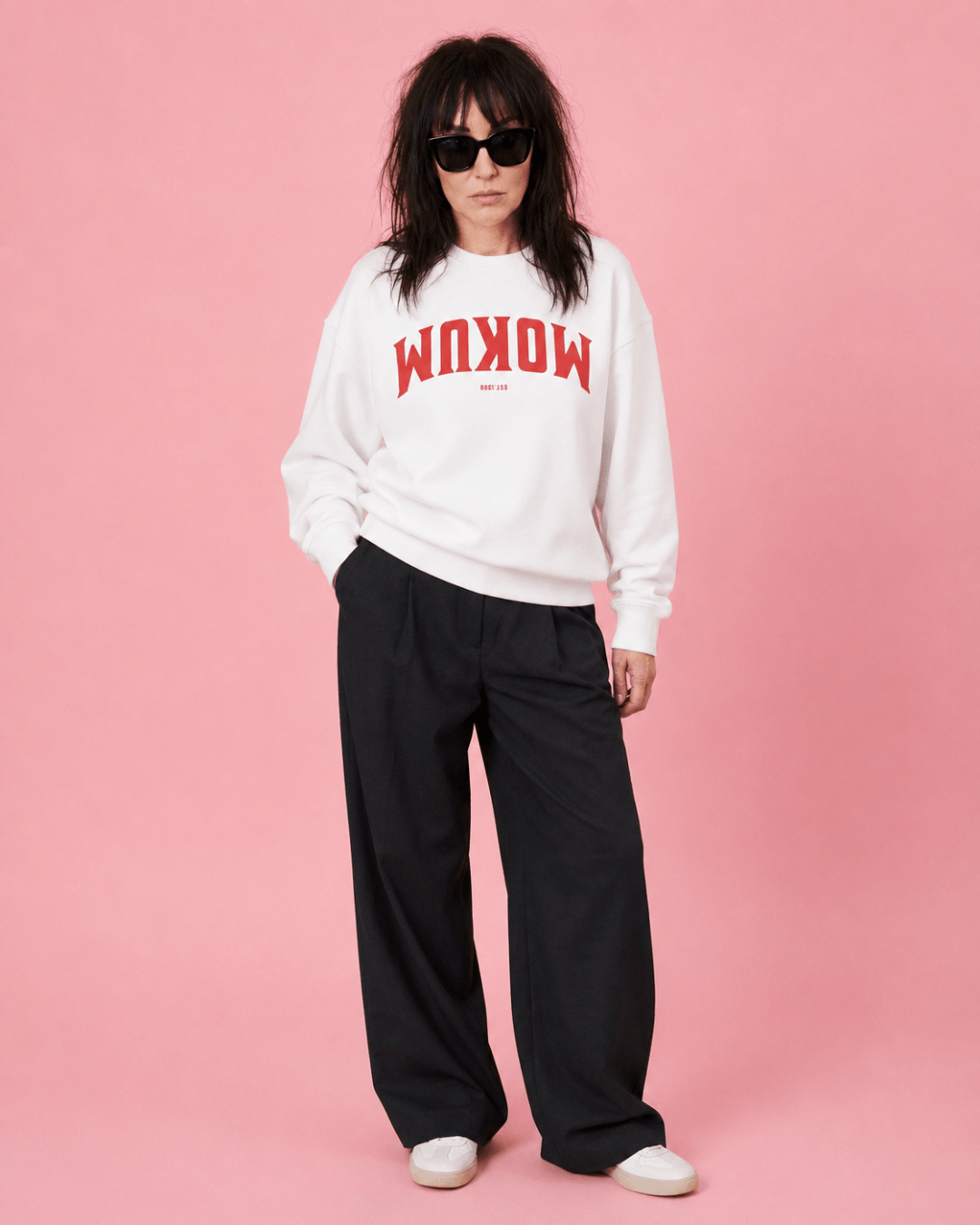 Mokum Est 1300 Heavy Sweater worn by a model against a pink backdrop.