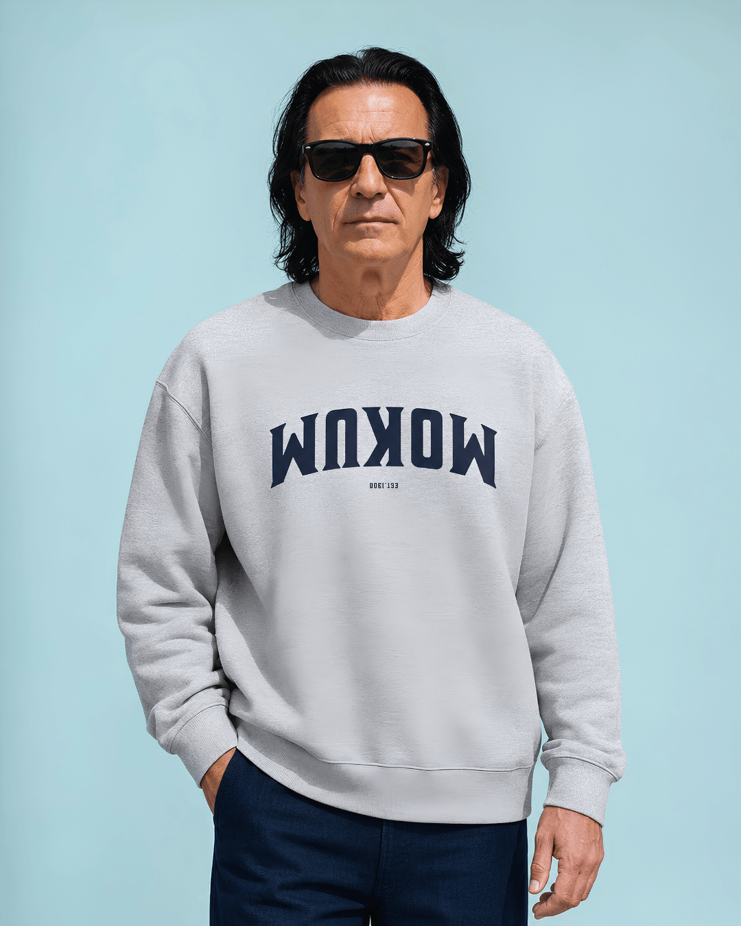 Mokum Est 1300 Heavy Sweater modeled by a man wearing sunglasses, showcasing urban style and comfort.