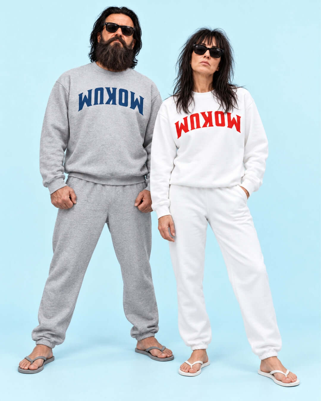 Walter and Helga wearing Sport Grey and White BINKY Mokum Soft Sweaters, showing the large navy and red reversed graphics.