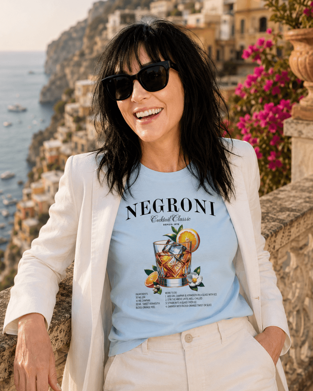Model wearing NEGRONI T-SHIRT | EXQUISITE LUXURY EDITION, stylishly posed with scenic background.