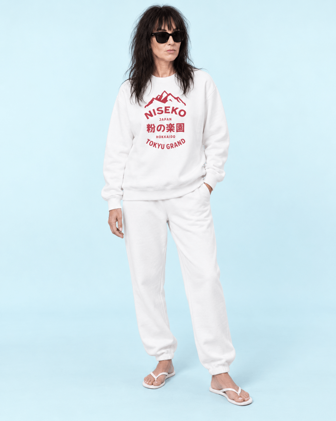 Niseko Powder Paradise Heavy Sweater worn by a model, showcasing bold typography and mountains design on a white background.
