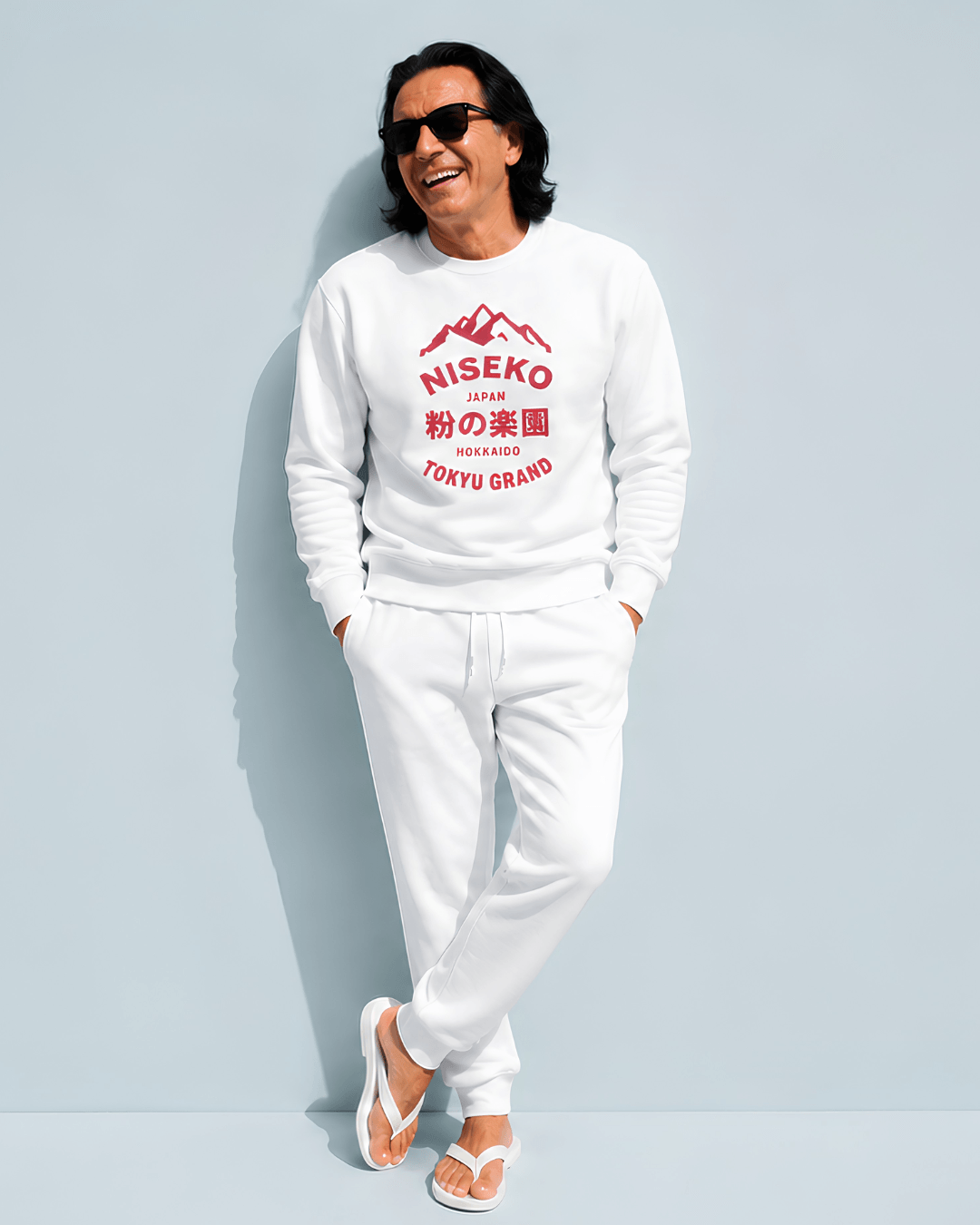 Niseko Powder Paradise Heavy Sweater worn by model, featuring mountain badge and bold typography.