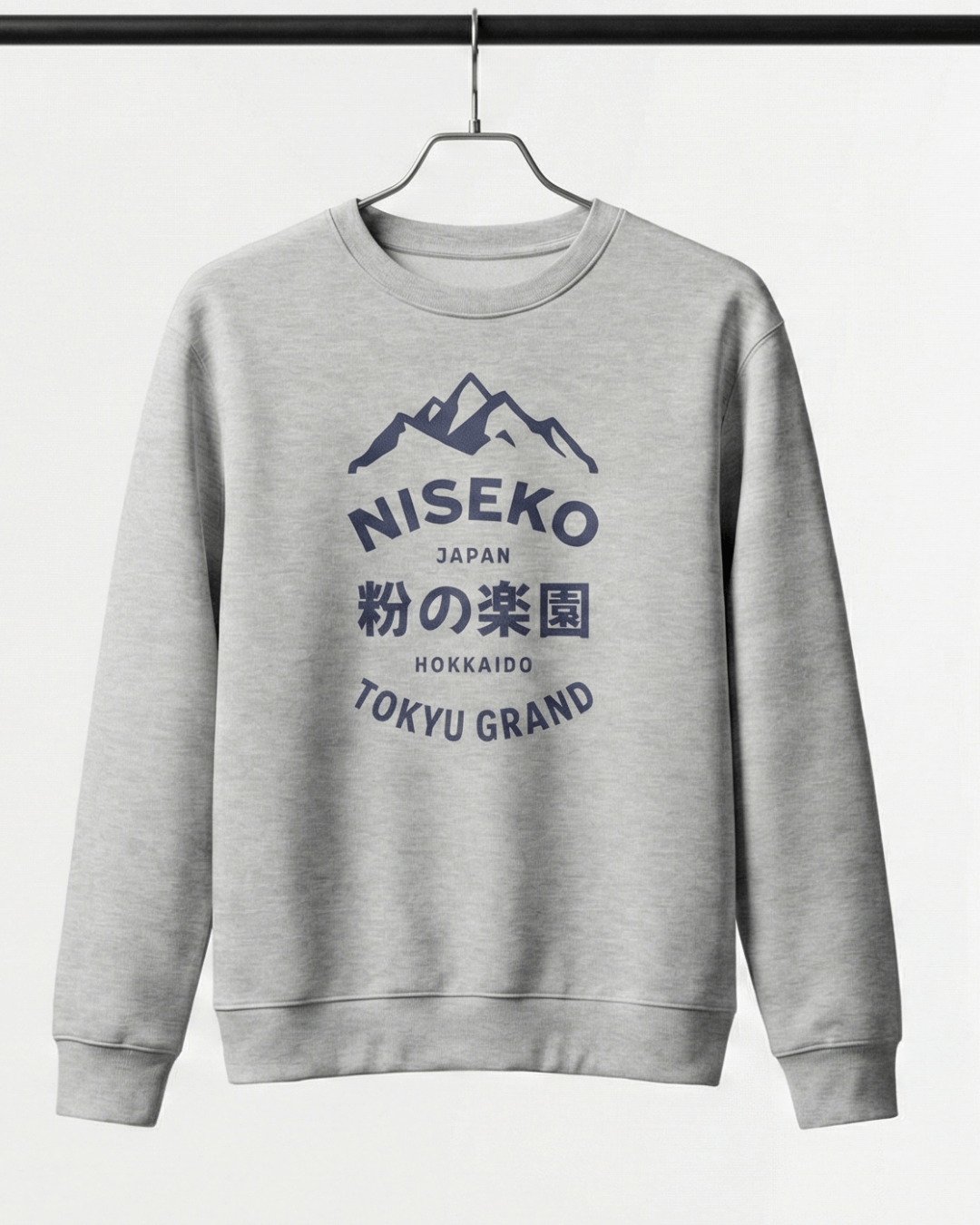 NISEKO POWDER PARADISE HEAVY SWEATER displayed on a hanger, showcasing mountain badge design and bold text.