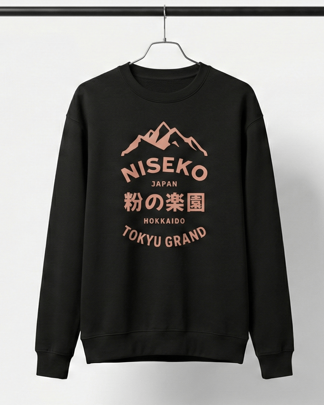 NISEKO POWDER PARADISE HEAVY SWEATER displayed on a hanger, featuring a mountain badge and bold text.