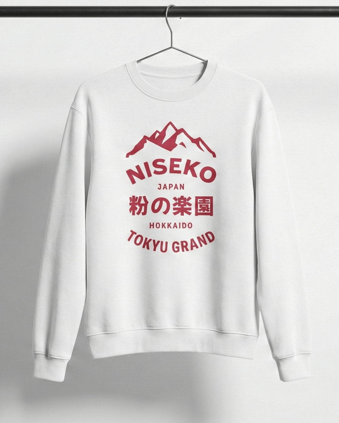NISEKO POWDER PARADISE HEAVY SWEATER featuring a mountain badge and bold text, hanging on a rack.