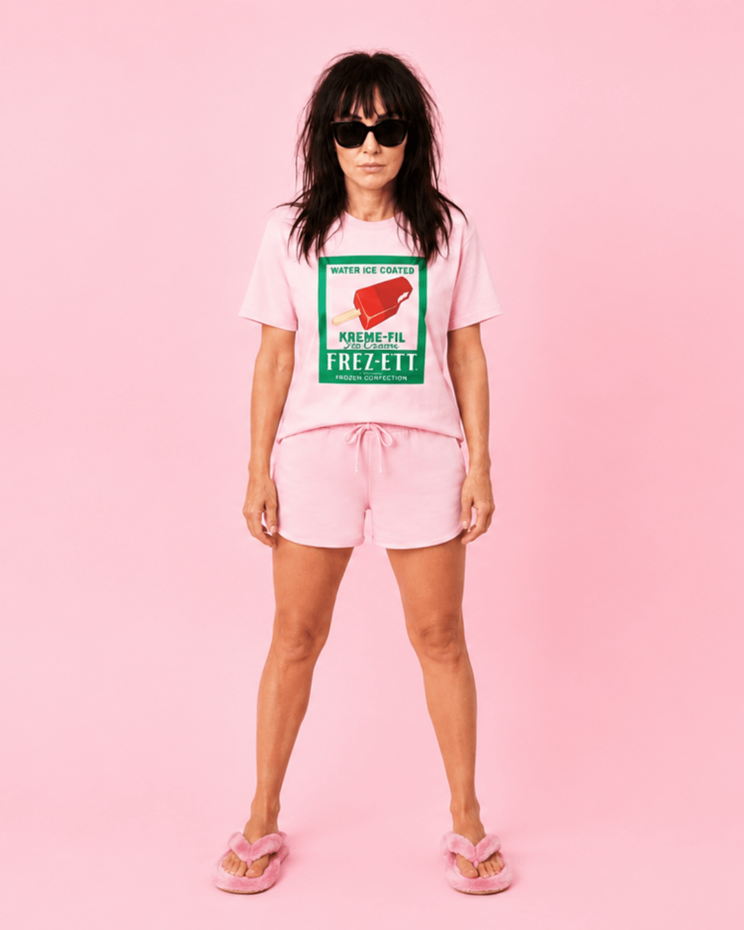 Popsicle T-Shirt | Vintage Americana Pop-art worn with pink shorts and sunglasses against a pink background.