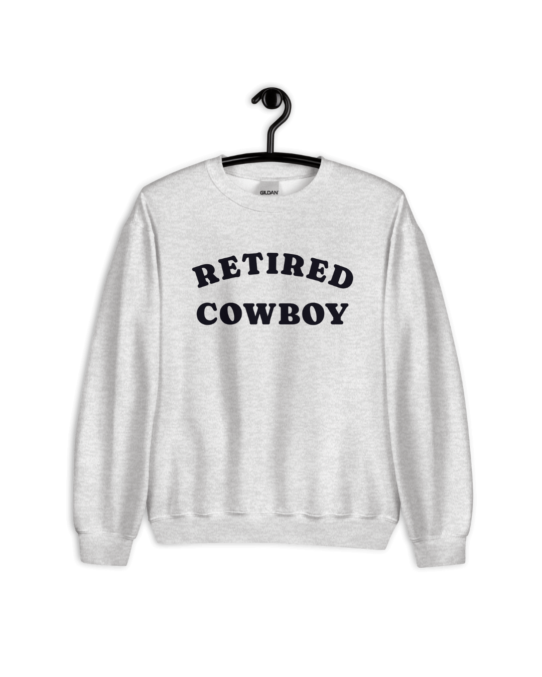 RETIRED COWBOY SWEATER displayed on a hanger, featuring a gray fabric with bold lettering.