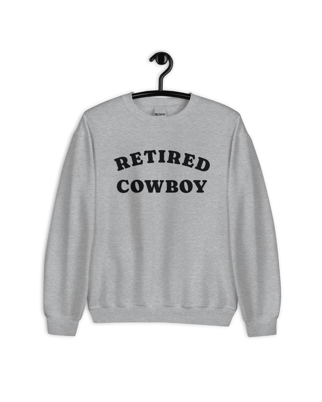 Retired Cowboy Sweater hanging on a hanger, showcasing its relaxed style and cozy fabric.