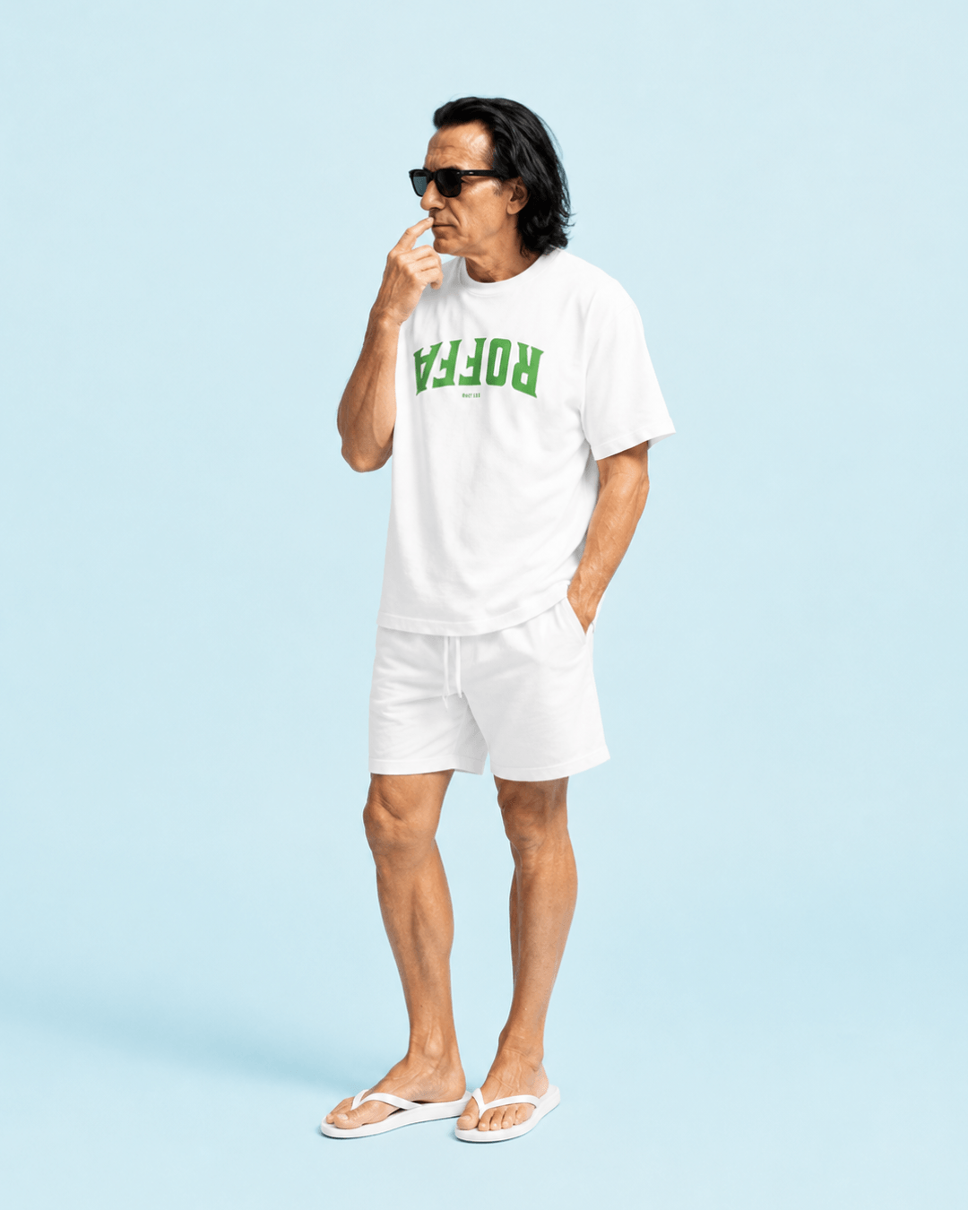 Man wearing Roffa Est. 1340 T-shirt | Harbour Hardline in white, posing against a light blue background.