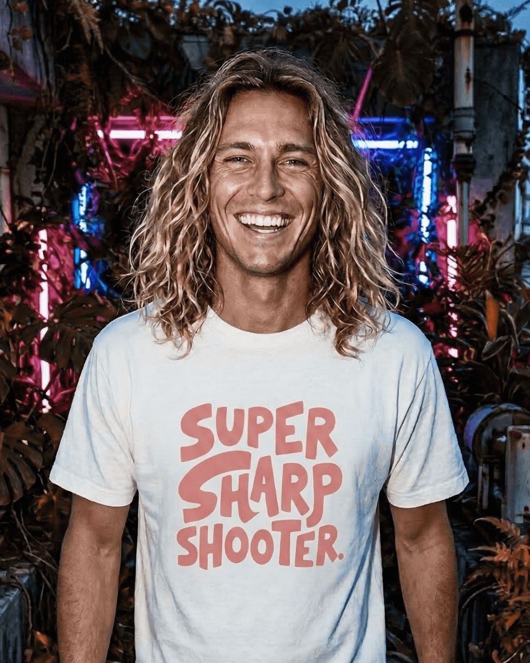 Happy person wearing SUPER SHARP SHOOTER T-SHIRT | ALWAYS HIT THE MARK with vibrant background.