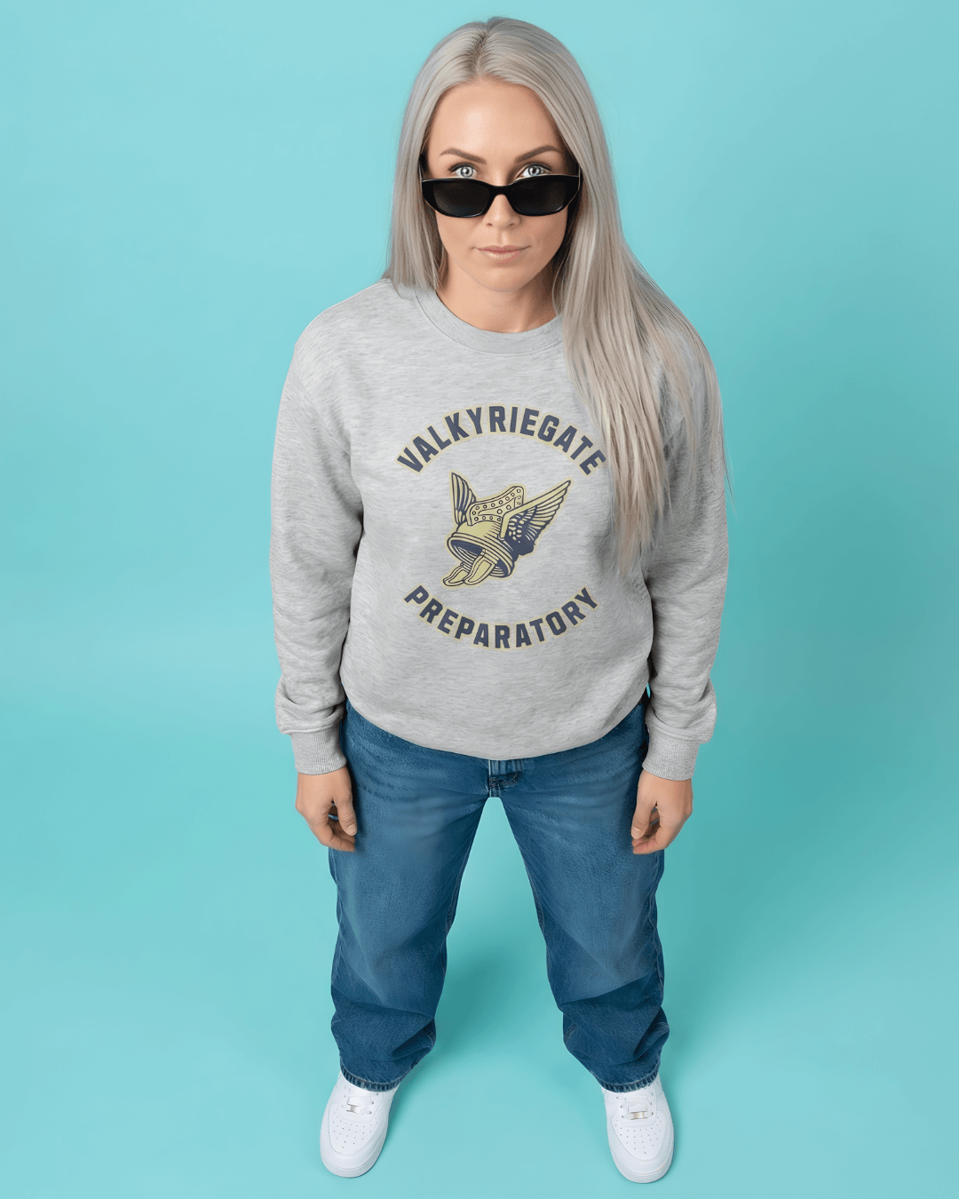 Model wearing VALKYRIE GATE HEAVY SWEATER with winged helmet emblem, styled in urban setting.